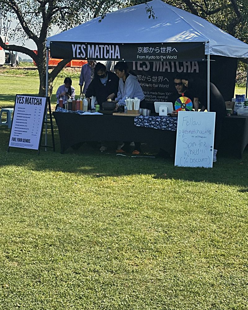 The YES MATCHA tent on the grass