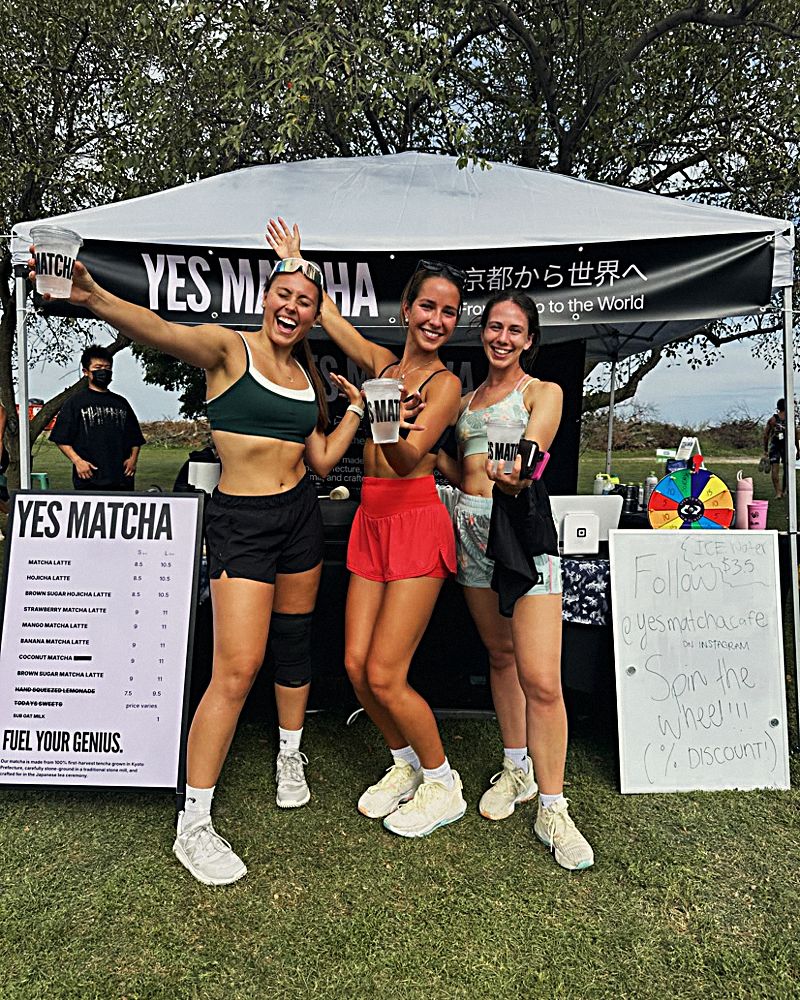 Friends with arms up at the matcha tent